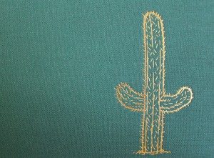 Gold foil embossed Cactus on the green fabric-wrapped cover