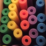 The many colors of a giant box of pool noodles.